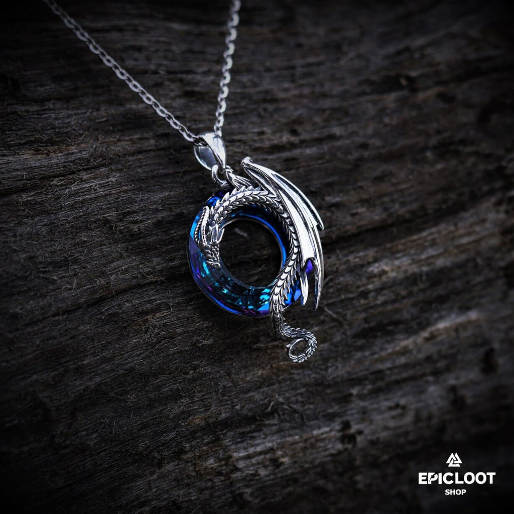 Dragon necklace with a round blue crystal stone.