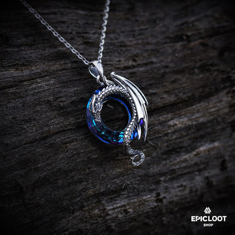 Dragon necklace with a round blue crystal stone.
