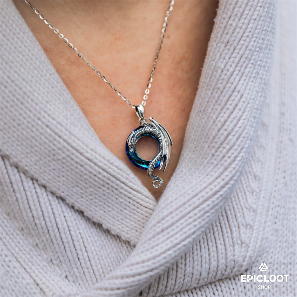 Dragon necklace with a round blue crystal stone.
