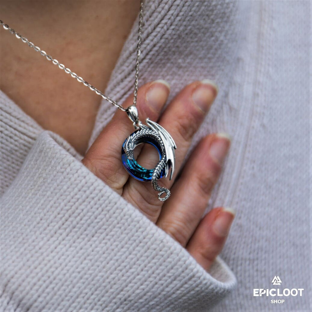 Dragon necklace with a round blue crystal stone.