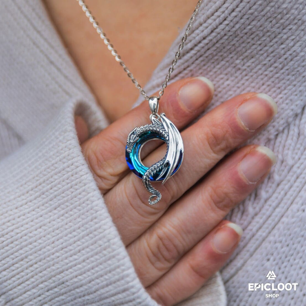 Dragon necklace with a round blue crystal stone.