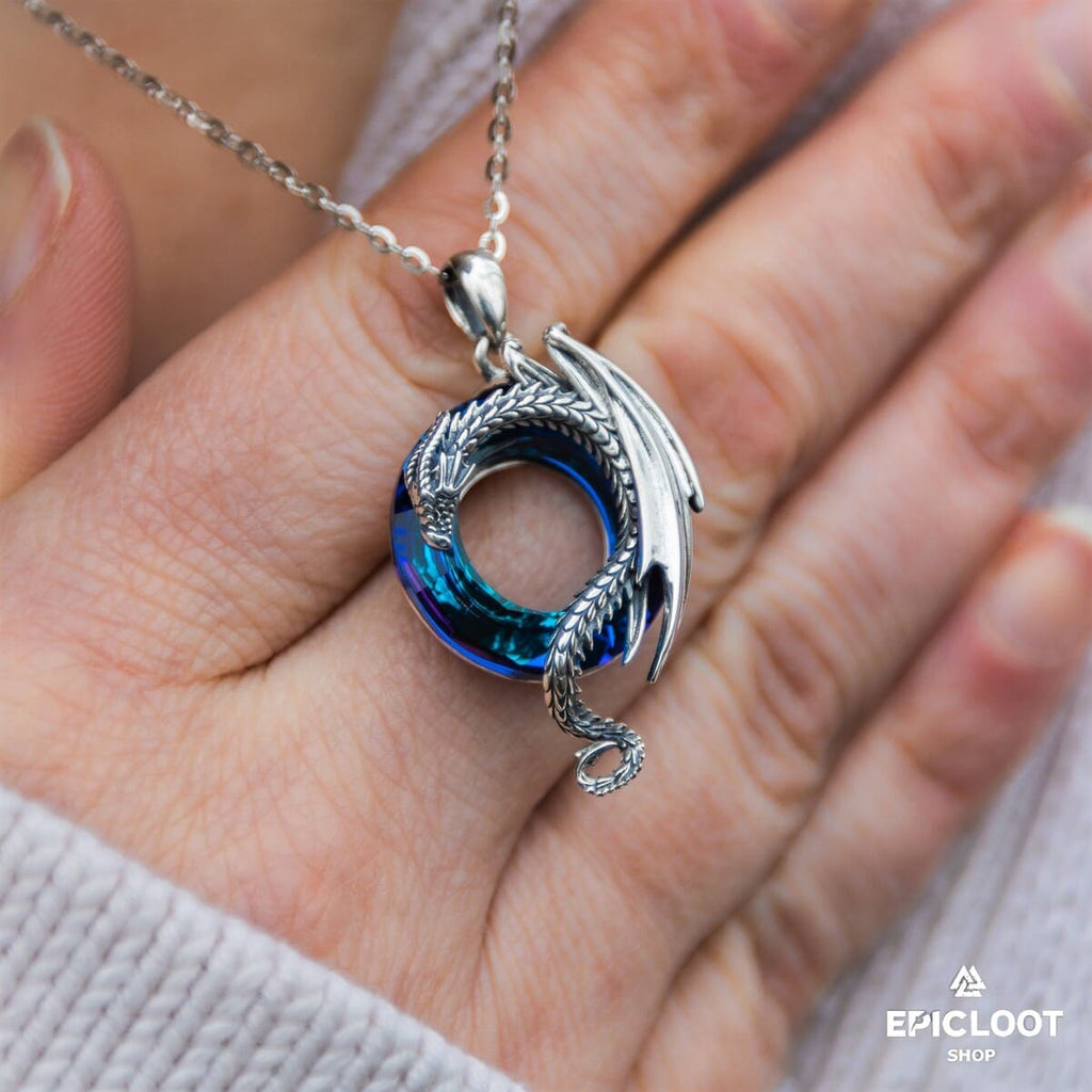 Dragon necklace with a round blue crystal stone.