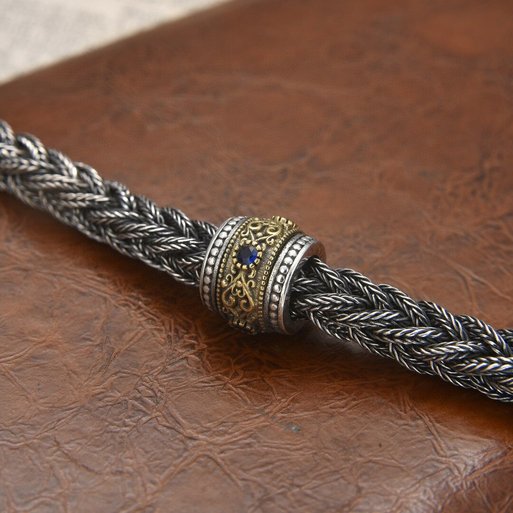 Elegant Antique-Influenced Bracelet and a Blue Corundum Stone